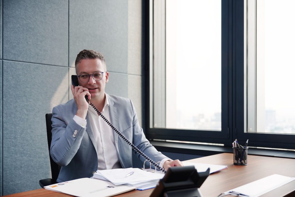 Corporate video still: an executive on the phone in a Ho Chi Minh City office tower