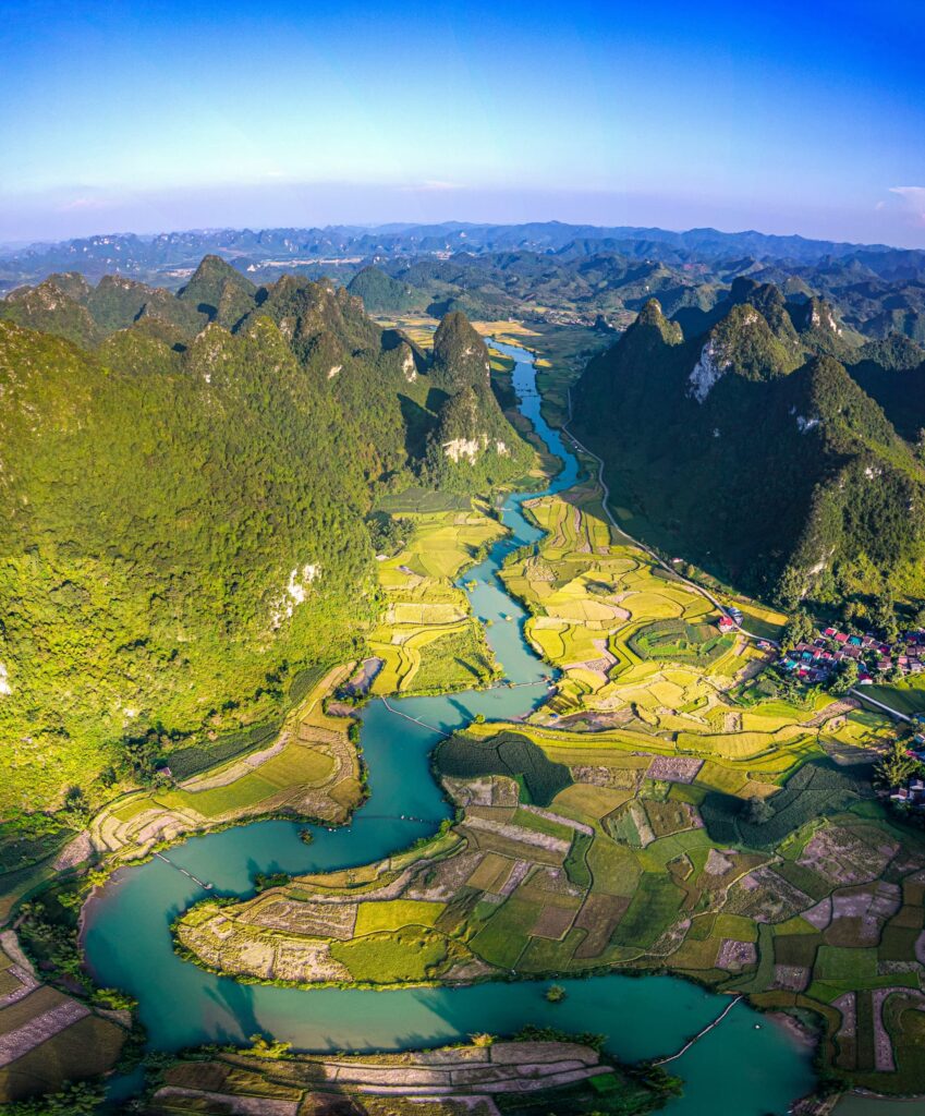 Aerial view of farmland, a river and mountain villages in Vietnam