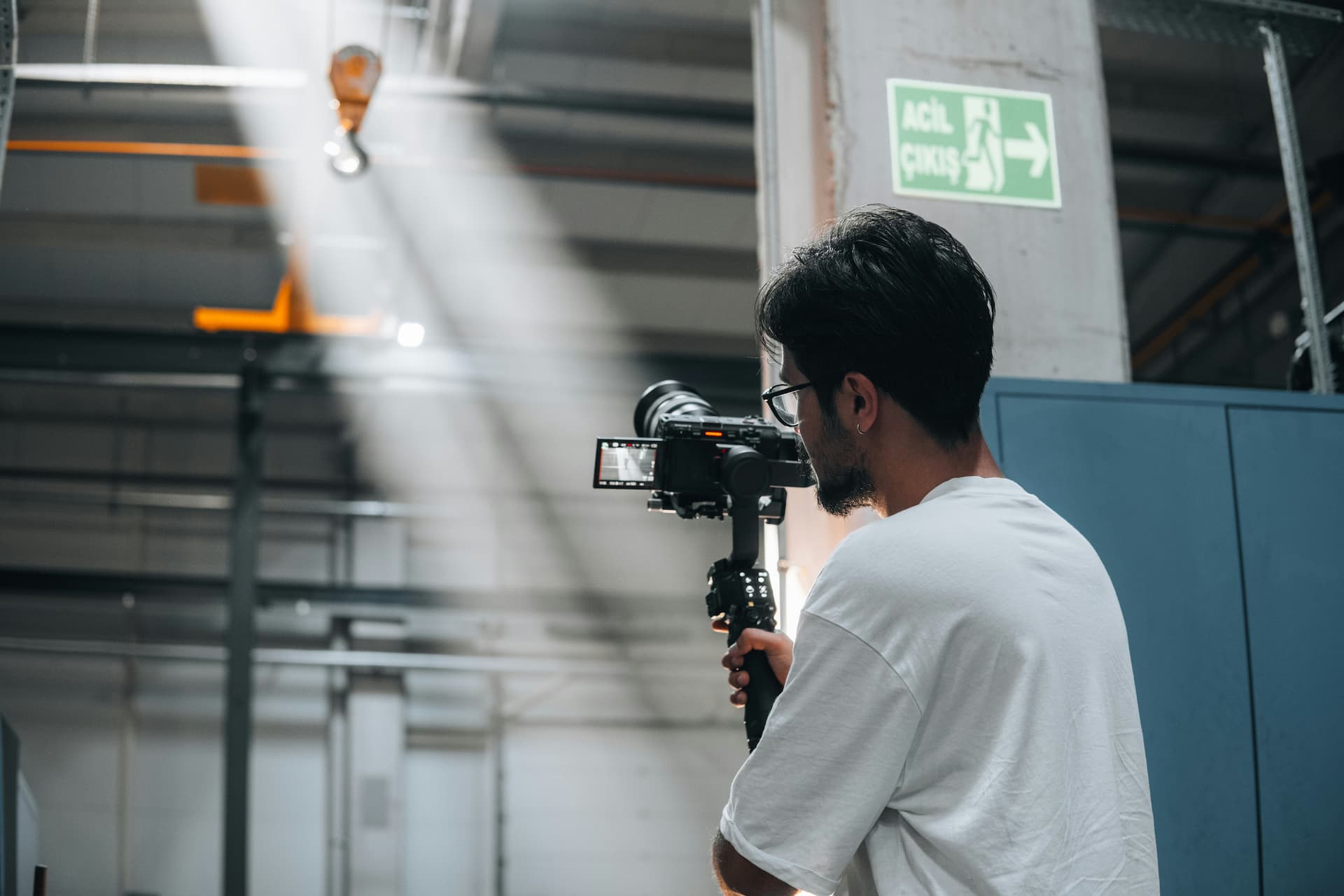 Camera operator filming inside an industrial plant