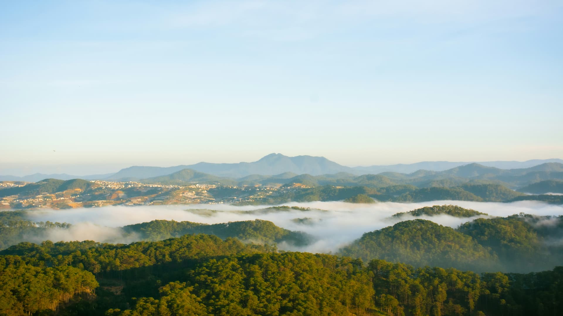 Misty mountains at sunrise in the highlands near Da Lat