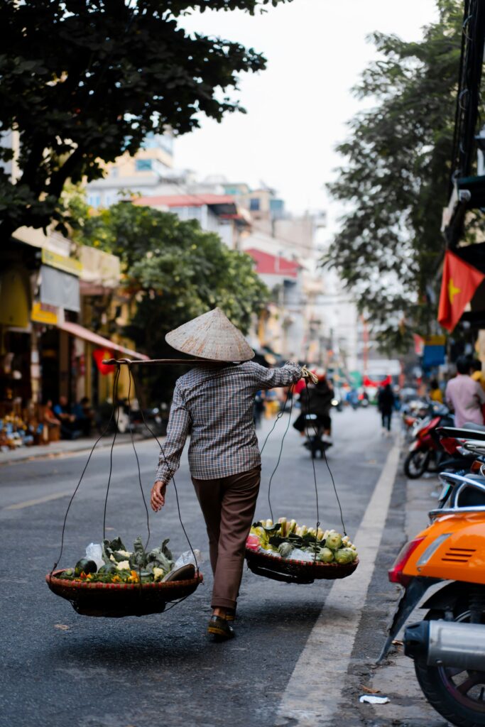 Street vendor shoulder baskets Hanoi